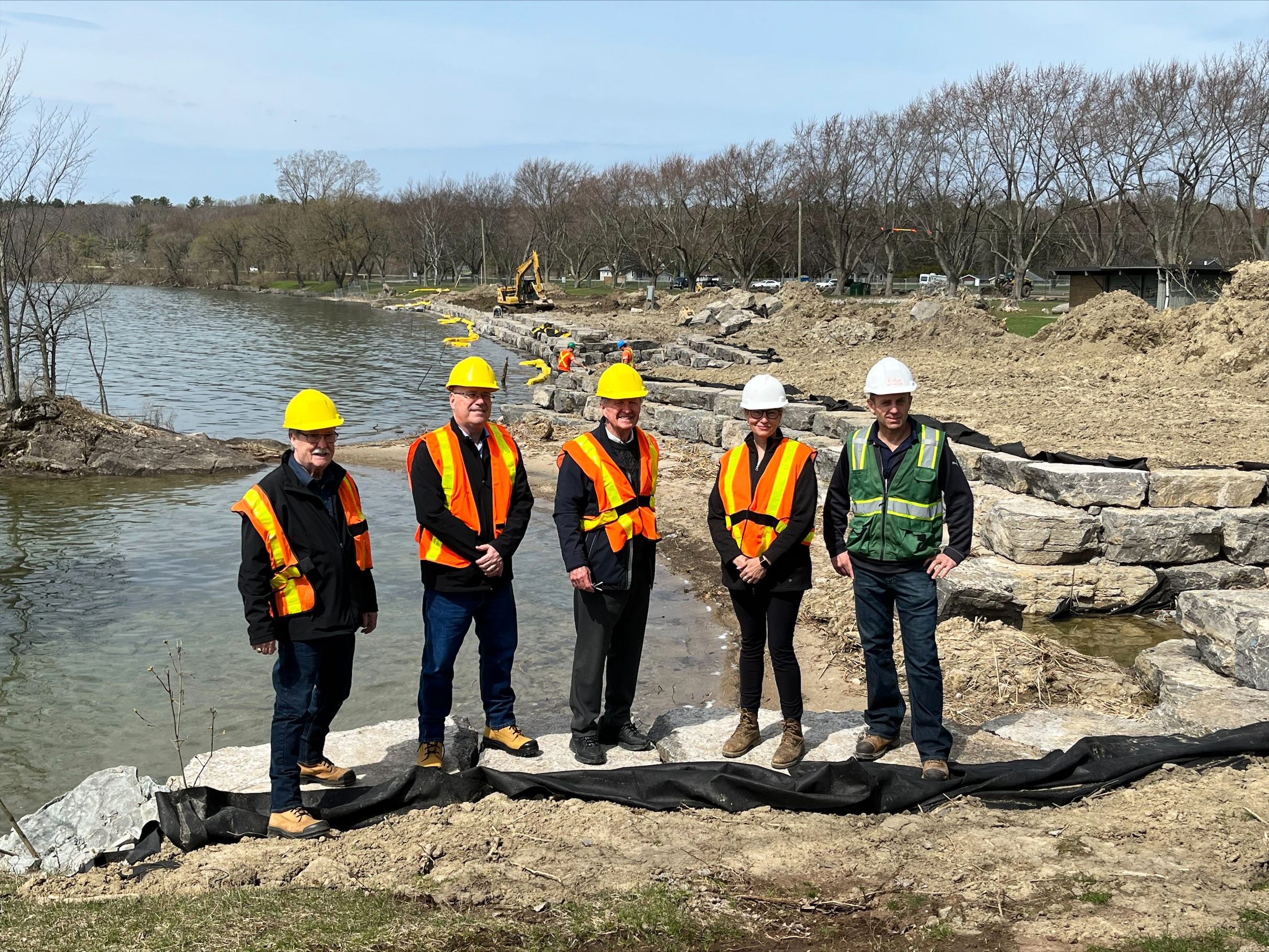 (L-R) Front of Yonge Township Mayor Roger Haley and Leeds-Grenville-Thousand Islands and Rideau Lakes MPP Steve Clark meet with St. Lawrence Parks Commission (SLPC) Chair, Hon. Bob Runciman; SLPC CEO & General Manager, Hollee Kew; and local contractors at Brown’s Bay Beach to celebrate the progress of construction on the park’s multi-year revitalization project.