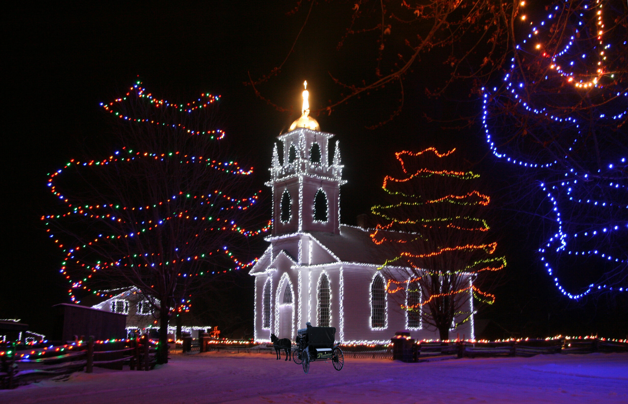 Christ Church at Upper Canada Village adorned in holiday lights during Alight at Night Festival.